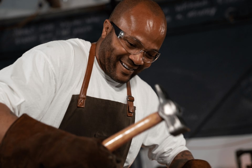 Blacksmith student hammering