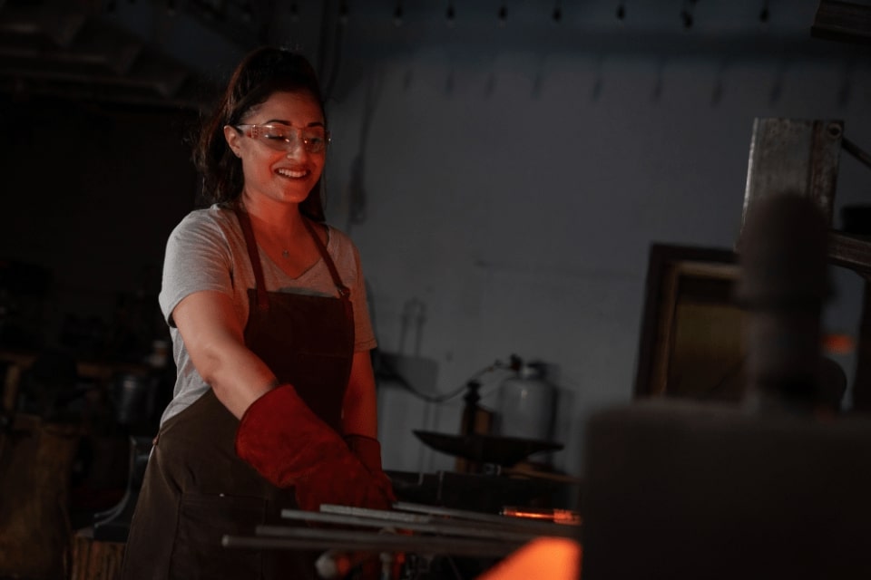 Blacksmithing student pulling metal